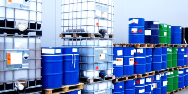 White,Container,And,Blue,Drums,On,An,Industrial,Storage,Site